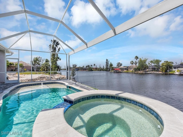 view of pool featuring glass enclosure, a pool with connected hot tub, and a water view