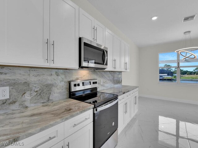 kitchen featuring visible vents, marble finish floor, light stone counters, stainless steel appliances, and baseboards