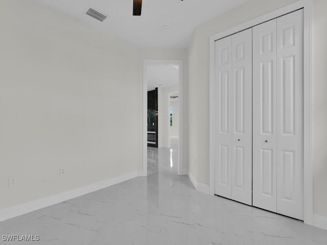 unfurnished bedroom with visible vents, marble finish floor, and baseboards