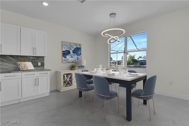 dining room with recessed lighting, baseboards, marble finish floor, and a chandelier