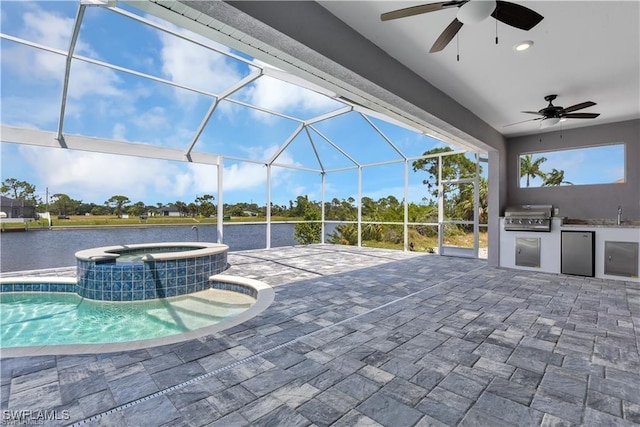 view of patio featuring an outdoor kitchen, area for grilling, a pool with connected hot tub, ceiling fan, and a lanai