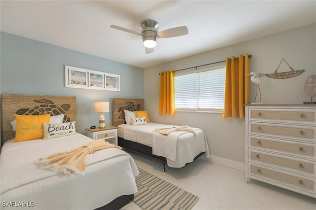 bedroom featuring a ceiling fan, light carpet, and baseboards