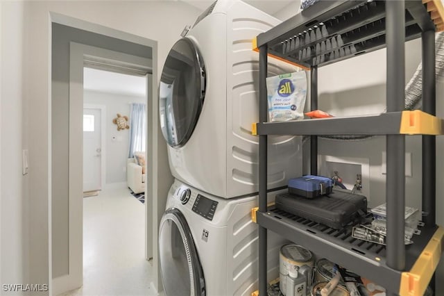 laundry room featuring laundry area and stacked washer / drying machine