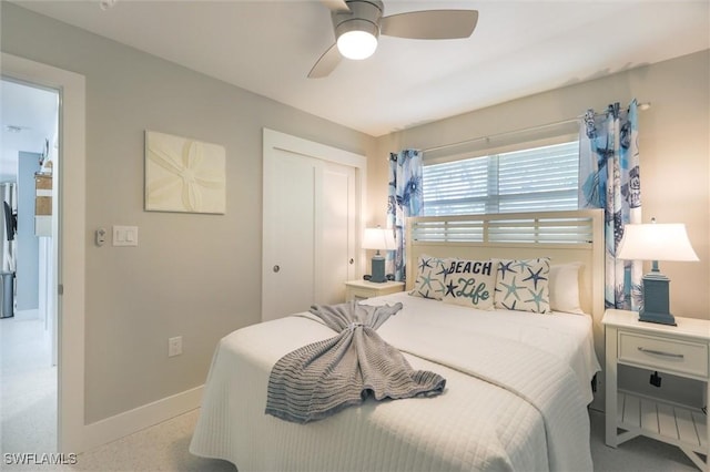 bedroom with a ceiling fan, baseboards, and a closet