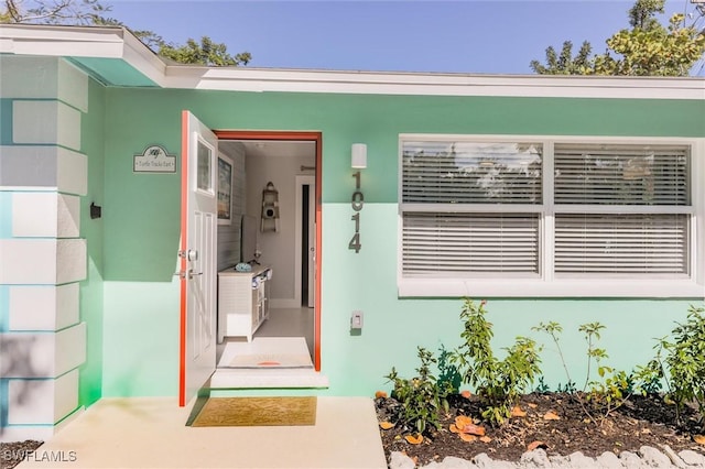 doorway to property with stucco siding