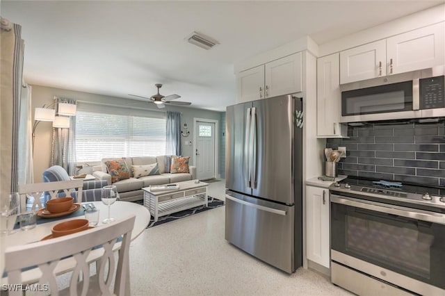 kitchen with white cabinetry, visible vents, appliances with stainless steel finishes, and decorative backsplash