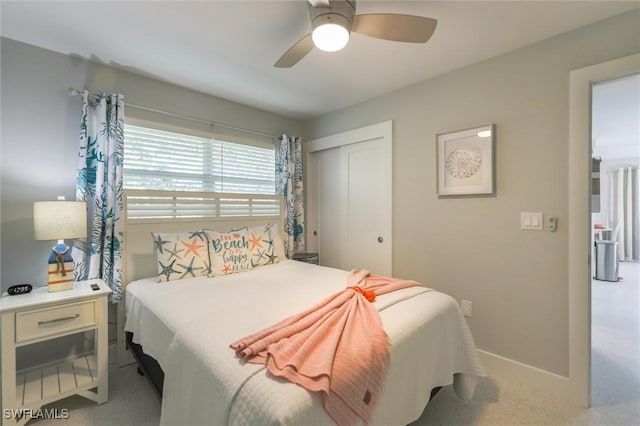 bedroom with ceiling fan, baseboards, a closet, and carpet flooring