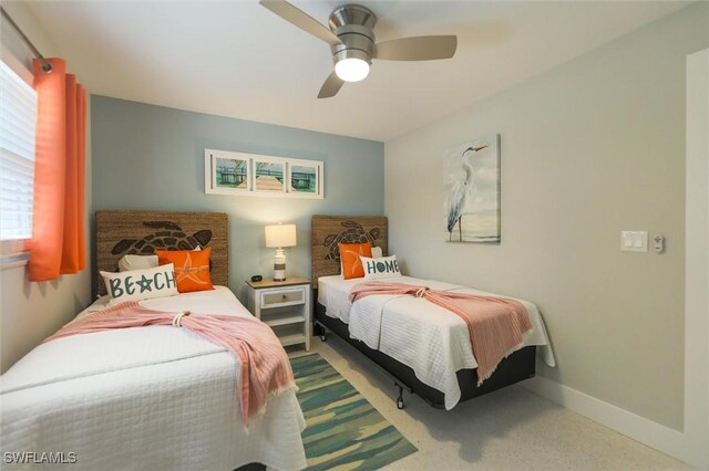 carpeted bedroom with a ceiling fan and baseboards