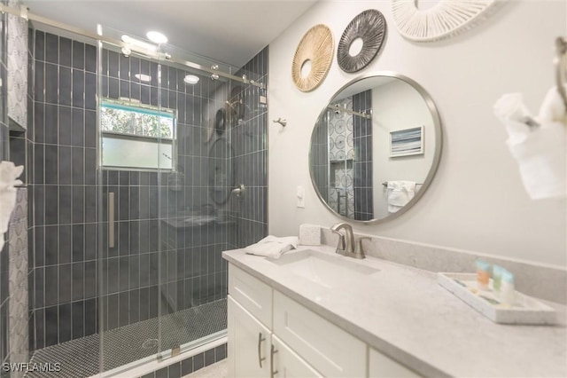 bathroom featuring a shower stall and vanity