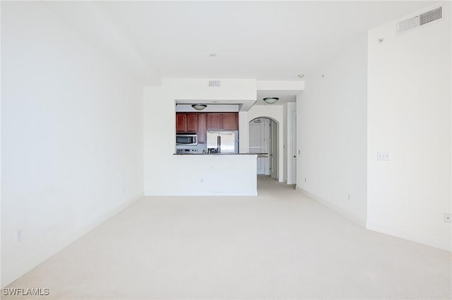 23159 Amgci Way Unit 3108, Estero, FL 33928 - unfurnished living room featuring light carpet, arched walkways, and baseboards