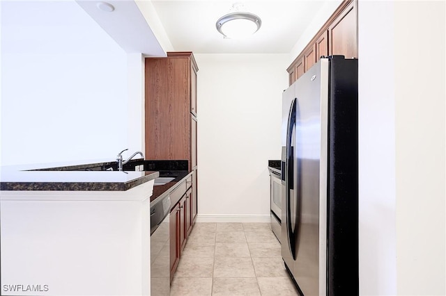 23159 Amgci Way Unit 3108, Estero, FL 33928 - kitchen featuring stainless steel appliances, dark countertops, a sink, and brown cabinets