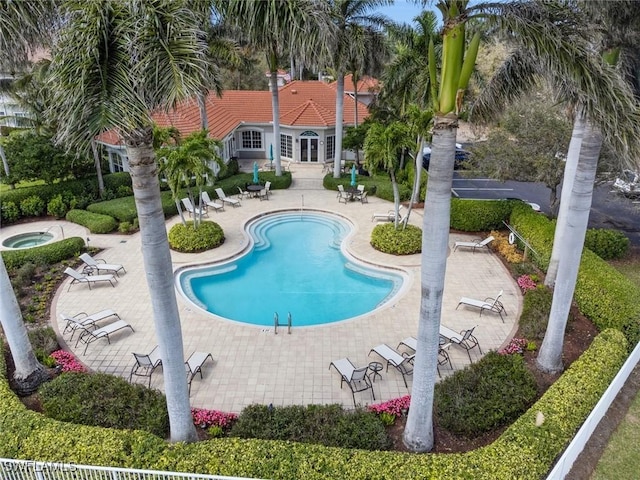 pool with a community hot tub and a patio