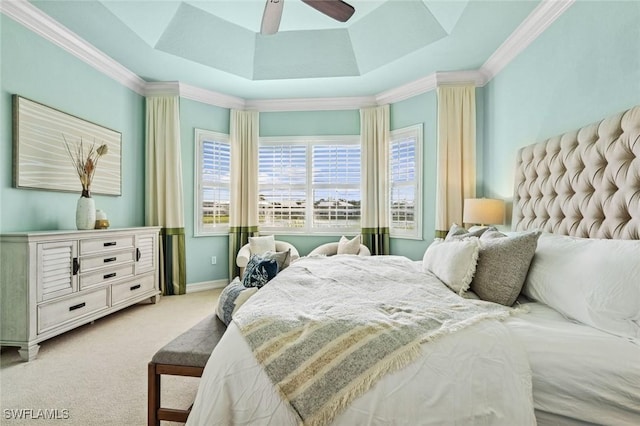 bedroom featuring ceiling fan, light colored carpet, baseboards, a raised ceiling, and crown molding