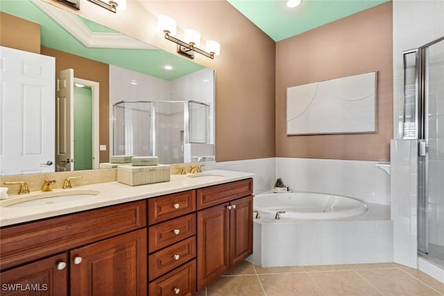 bathroom with a garden tub, double vanity, a stall shower, a sink, and tile patterned floors