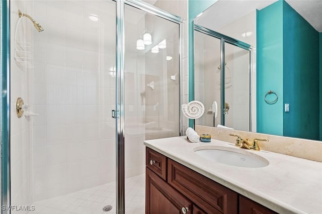 bathroom with a shower stall and vanity