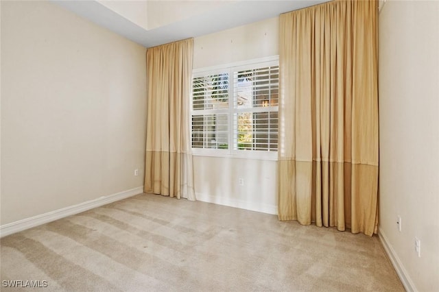 spare room with carpet and baseboards