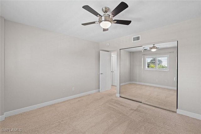 unfurnished bedroom featuring baseboards, visible vents, ceiling fan, carpet flooring, and a closet