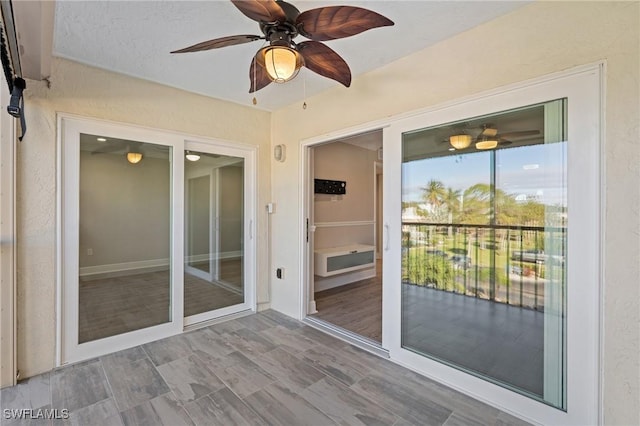 unfurnished sunroom with a ceiling fan