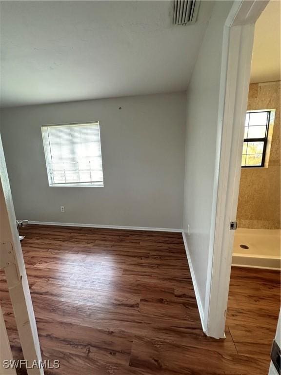 interior space featuring wood finished floors, visible vents, and baseboards