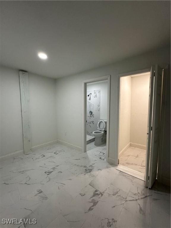 interior space featuring marble finish floor, baseboards, and recessed lighting