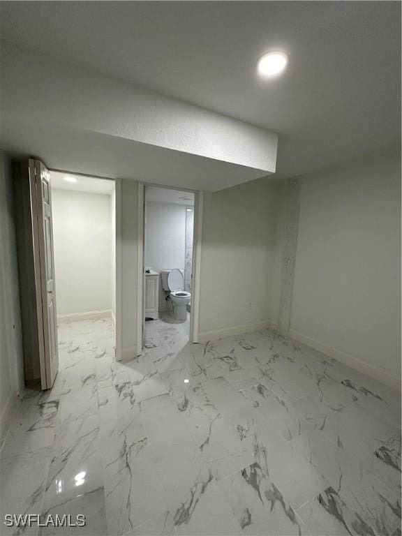 finished below grade area featuring marble finish floor and baseboards