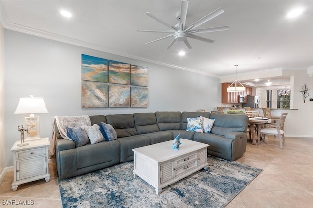 living room featuring light tile patterned floors, ceiling fan, baseboards, and crown molding