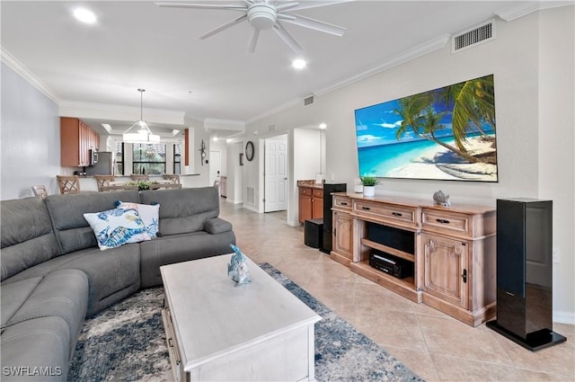 living area with light tile patterned floors, ceiling fan, ornamental molding, and visible vents