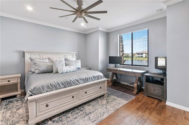 bedroom with baseboards, ceiling fan, hardwood / wood-style flooring, and crown molding