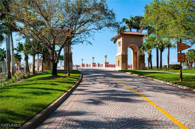 view of road featuring curbs, traffic signs, and sidewalks