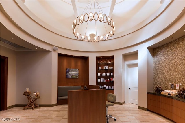 reception featuring a community bar and an inviting chandelier