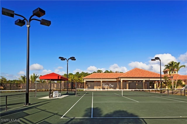 view of tennis court featuring fence