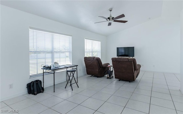 living area featuring lofted ceiling, light tile patterned floors, and ceiling fan