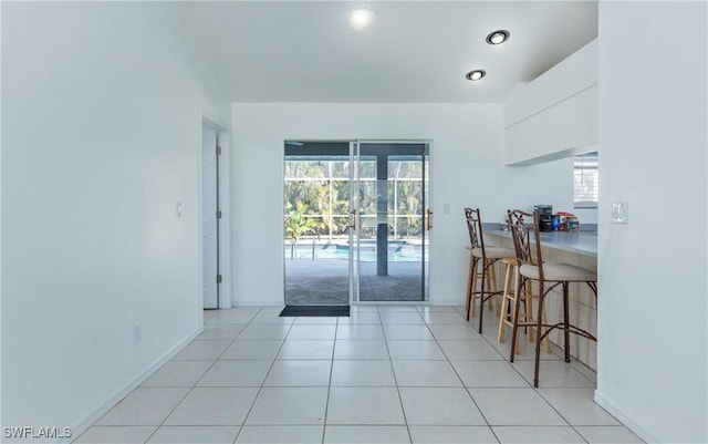 interior space with light tile patterned flooring, recessed lighting, and baseboards