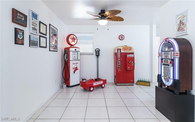 interior space featuring light tile patterned flooring and a ceiling fan