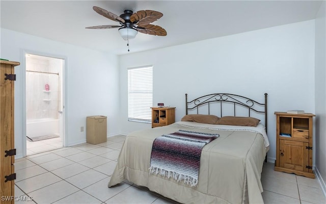 bedroom with ceiling fan, light tile patterned floors, baseboards, and connected bathroom