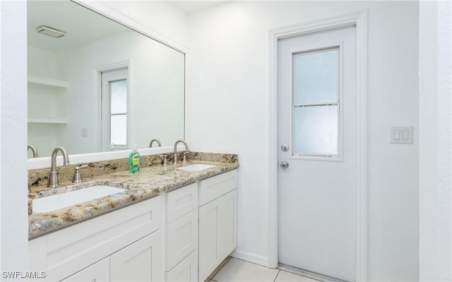 bathroom with tile patterned flooring, double vanity, and a sink