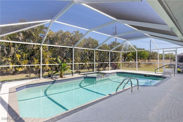 view of swimming pool with a lanai, a pool with connected hot tub, and a patio