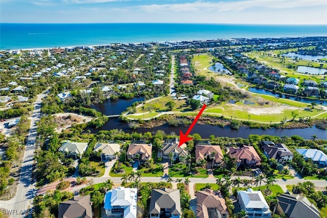 birds eye view of property with a water view and a residential view