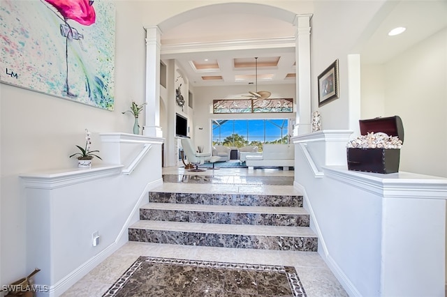 staircase with decorative columns, coffered ceiling, beamed ceiling, a high ceiling, and recessed lighting