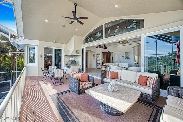 deck with a lanai, outdoor lounge area, ceiling fan, and grilling area