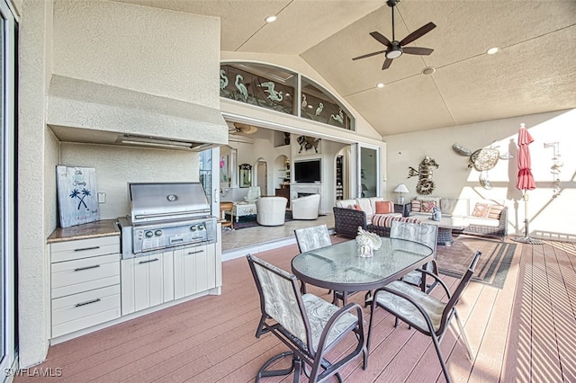 deck featuring outdoor dining space, grilling area, an outdoor living space, and a ceiling fan