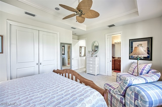 bedroom featuring ornamental molding, visible vents, a raised ceiling, and light colored carpet