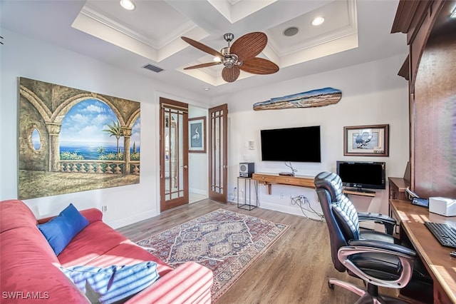 office space featuring coffered ceiling, wood finished floors, visible vents, baseboards, and ornamental molding