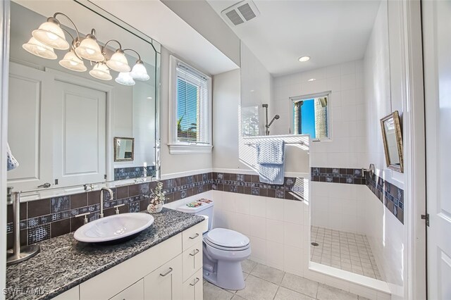 full bathroom with a walk in shower, toilet, plenty of natural light, and visible vents