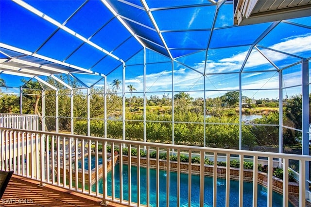 view of pool featuring a fenced in pool and glass enclosure