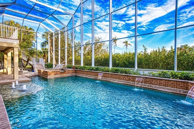 outdoor pool featuring glass enclosure, stairway, and a patio