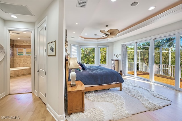 bedroom with light wood finished floors, access to outside, multiple windows, and visible vents