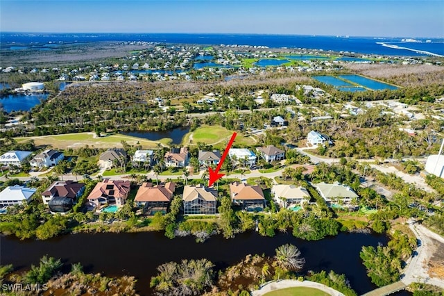 bird's eye view featuring a water view and a residential view