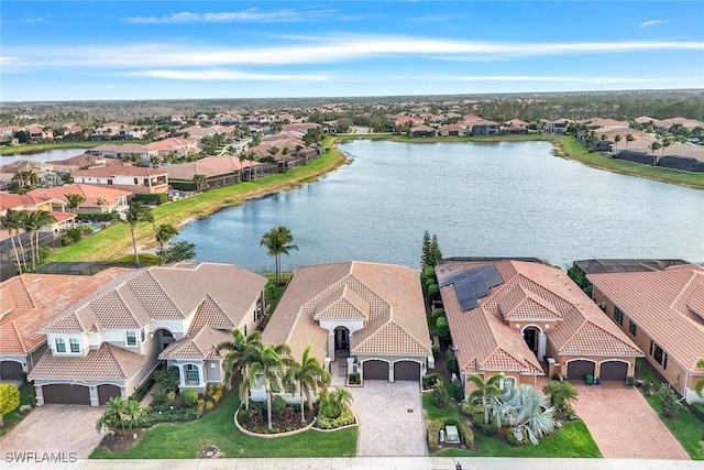 birds eye view of property with a water view and a residential view