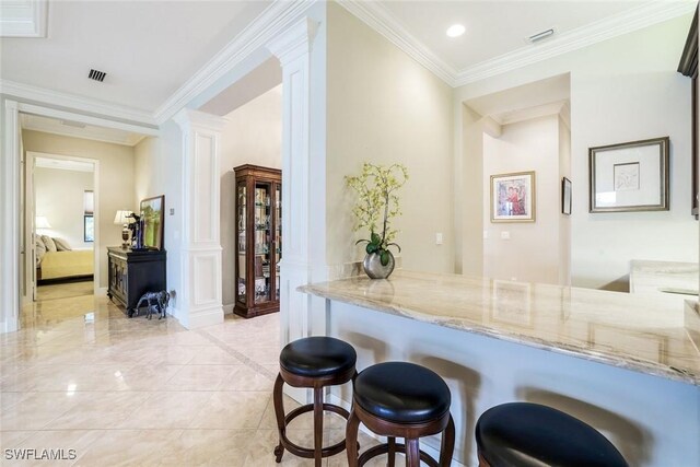 bar with recessed lighting, visible vents, crown molding, and ornate columns